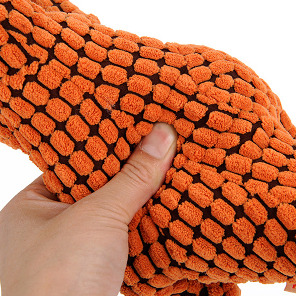 orange plush dinosaur dog toy with soft textured corn velvet fabric