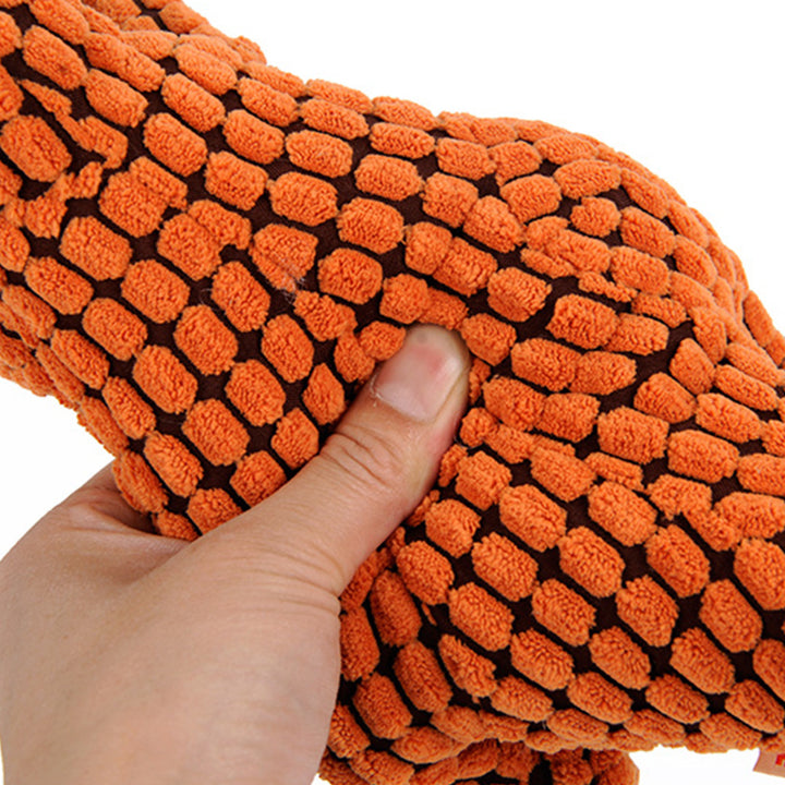 orange plush dinosaur dog toy with soft textured corn velvet fabric